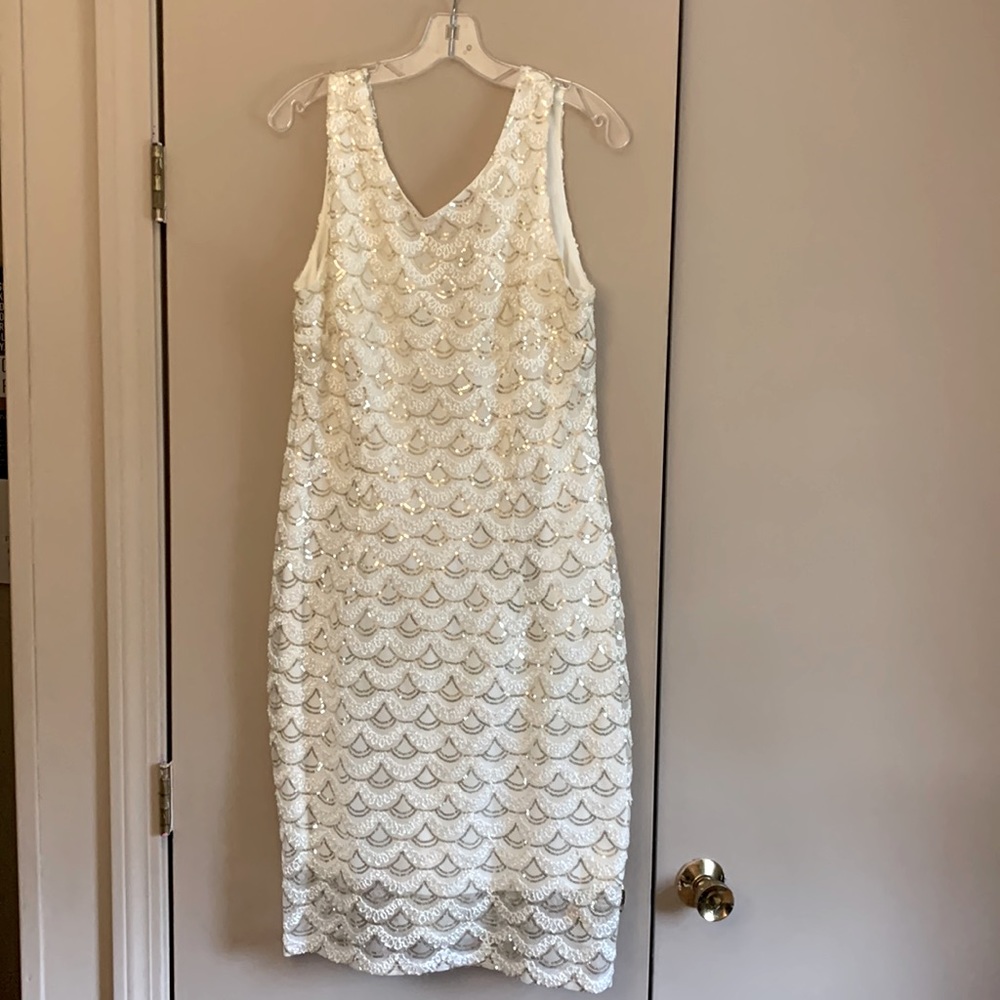 This is an SD Collection dress, size 16. It’s white with gold details.